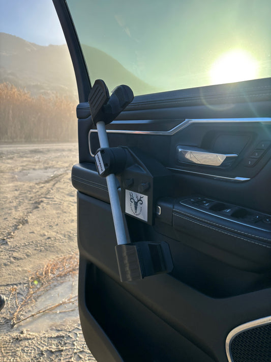 Gun rack for vehicle interior, mounts securely to the door handle, providing safe and efficient access to rifles or shotguns while hunting or recreating. 